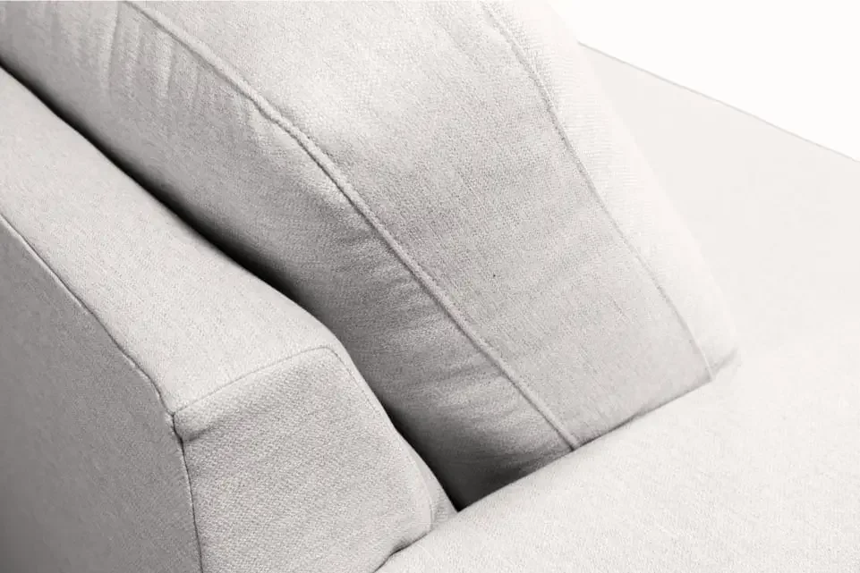 Close-up of plush back and seat cushions on a SIXTREND sofa in light grey textured upholstery, showing seam detail.