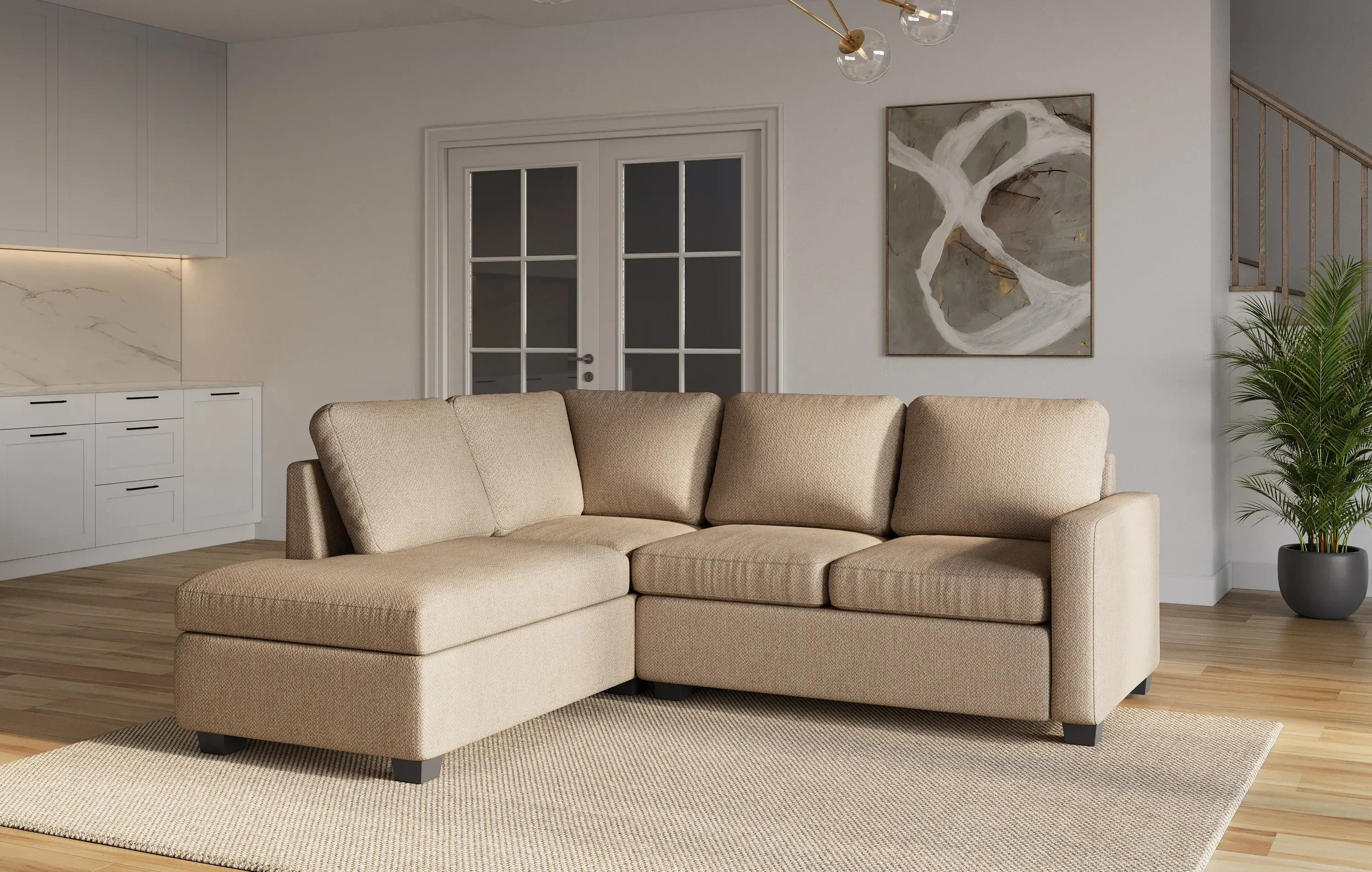 Beige sectional sofa with a chaise on a textured area rug in a modern living room with abstract wall art and patio doors.